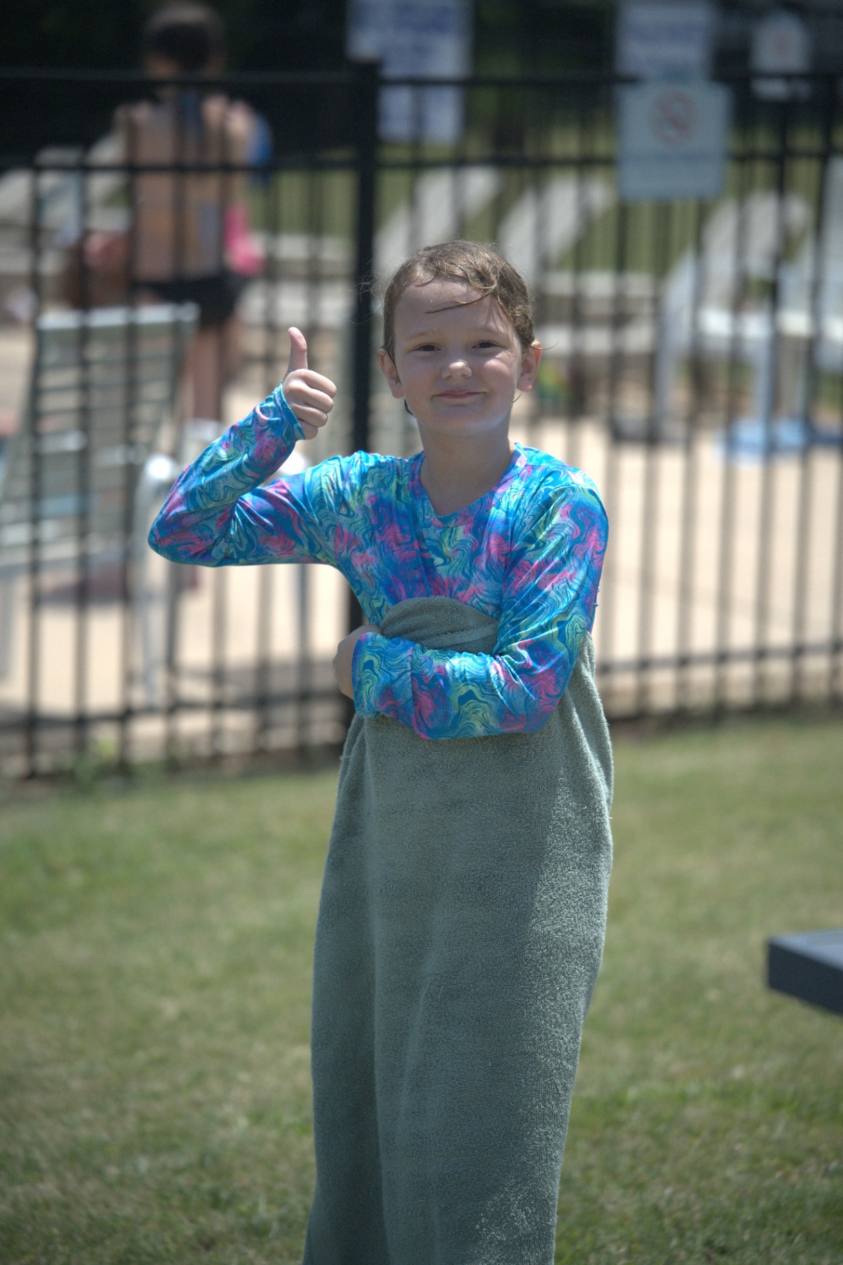 Young resident giving a thumbs up after swimming
